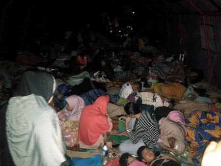 Locals rest outside a mosque as they being sheltered following earthquake hit in South Halmahera, North Maluku