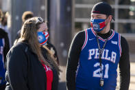 Fans wait in line to enter the Wells Fargo Center prior to an NBA basketball game between the San Antonio Spurs and the Philadelphia 76ers, Sunday, March 14, 2021, in Philadelphia. (AP Photo/Chris Szagola)