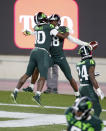 Michigan State's Michael Dowell, left, Kalon Gervin, center, and Tre Person, right, celebrate Gervin's fumble recovery for a touchdown at the conclusion of an NCAA college football game against Northwestern, Saturday, Nov. 28, 2020, in East Lansing, Mich. (AP Photo/Al Goldis)