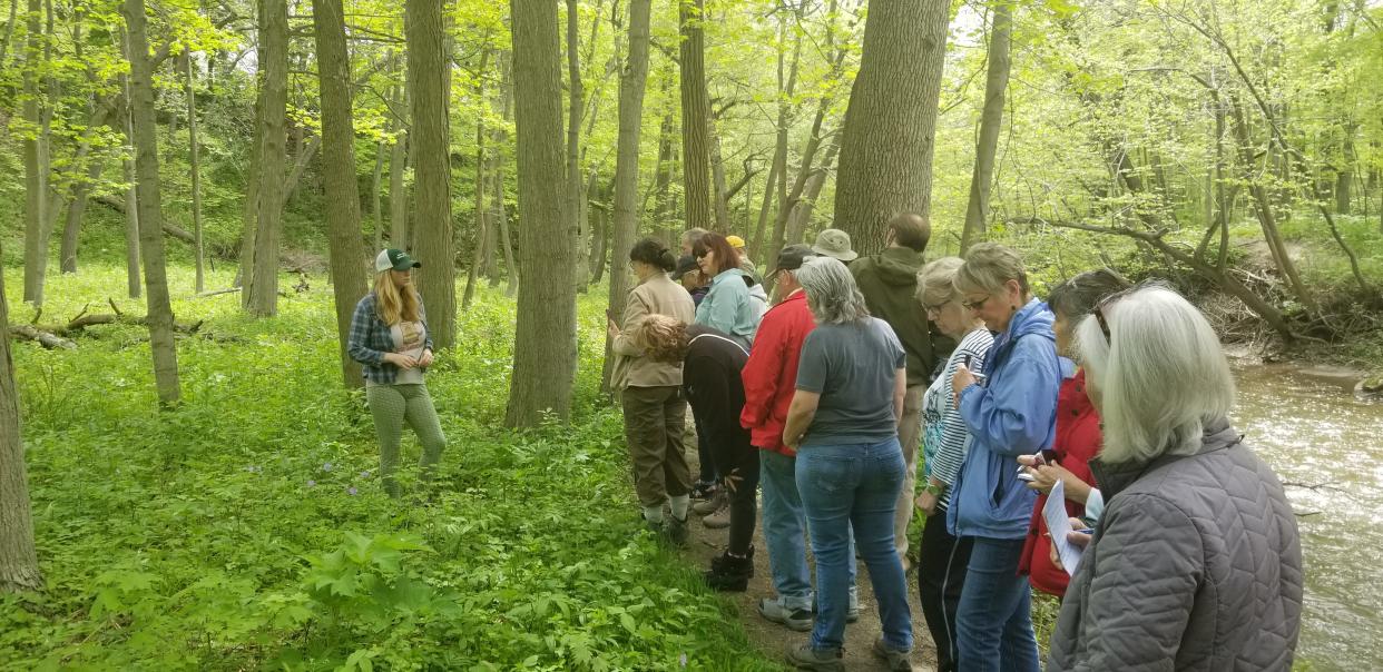The Suburban Soles event series in South Milwaukee offers free guided walks through Grant Park with experts in various fields from plants and fungi to history. Here, Sierra Dawkins, a botanist with the eastern region forest service, instructs some Suburban Soles participants in 2019.