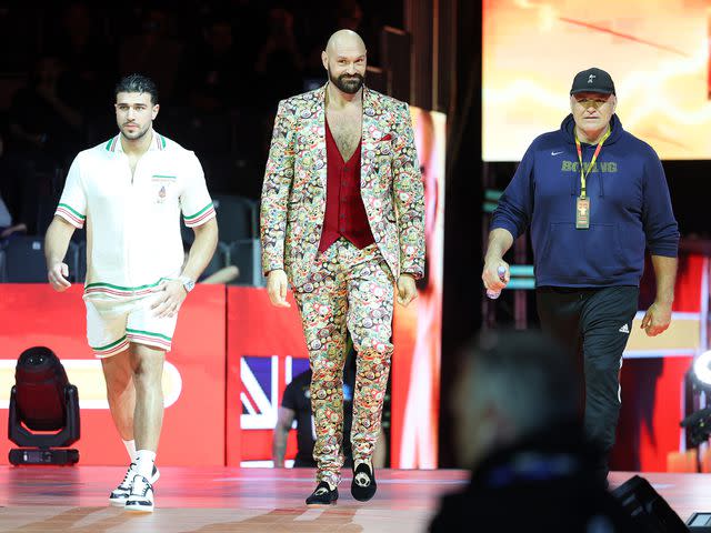 <p>Mark Robinson/Matchroom Boxing/Getty</p> Tyson Fury, Tommy Fury and John Fury at Kingdom Arena on March 8, 2024
