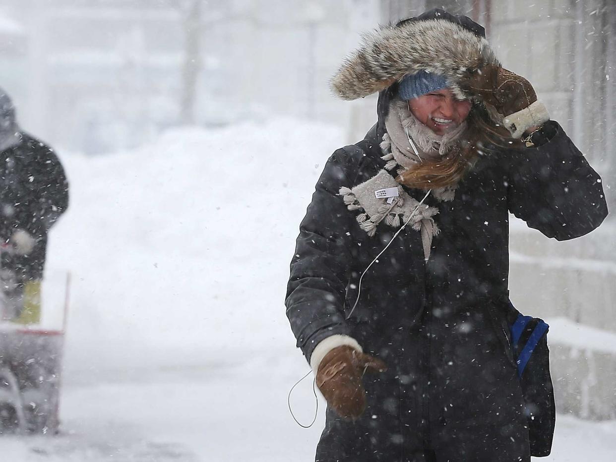 An American woman battles through a snow storm in 2013: Getty