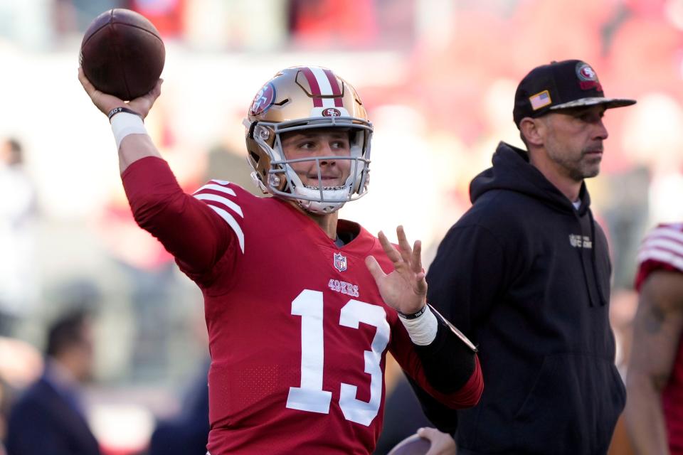 San Francisco 49ers quarterback Brock Purdy warms up next to head coach Kyle Shanahan before an NFC divisional playoff game against the Dallas Cowboys in Santa Clara, Calif., Sunday, Jan. 22, 2023.