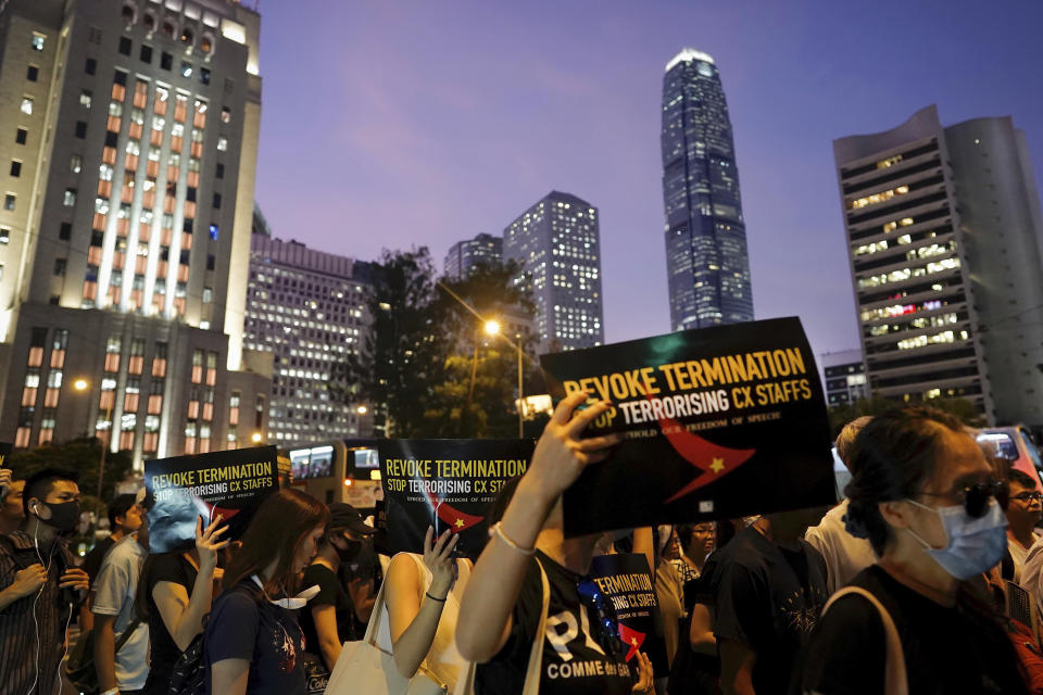 Demonstrators hold signs opposing the recent firings of Cathay Pacific employees as they gather for a demonstration at the Edinburgh Square in Hong Kong, Wednesday, Aug. 28, 2019. Trade union members in Hong Kong are rallying against the city's flagship Cathay Pacific airline for firing employees linked to ongoing pro-democracy protests. (AP Photo/Vincent Yu)