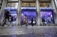 Pedestrians pass the storefront of Peter Nygard's Times Square headquarters, Tuesday, Feb. 25, 2020, in New York. Federal authorities on Tuesday, Feb. 25, 2020, raided the Manhattan headquarters of the Canadian fashion mogul Peter Nygard amid claims that he sexually assaulted and trafficked dozens of teenage girls and young women. (AP Photo/John Minchillo)