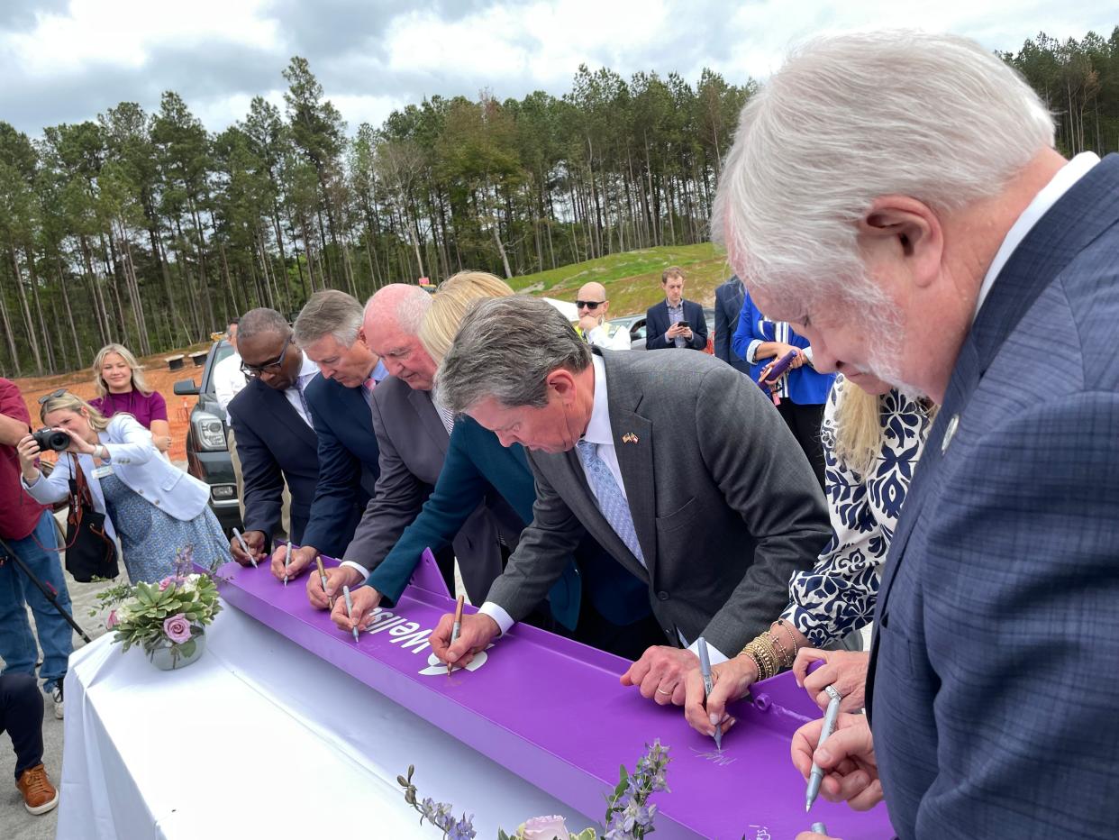 Augusta University President Dr. Brooks Keel (far right) joins other officials in signing a ceremonial crossbeam for the new Wellstar Columbia County Medical Center, April 1,2024, in Grovetown.