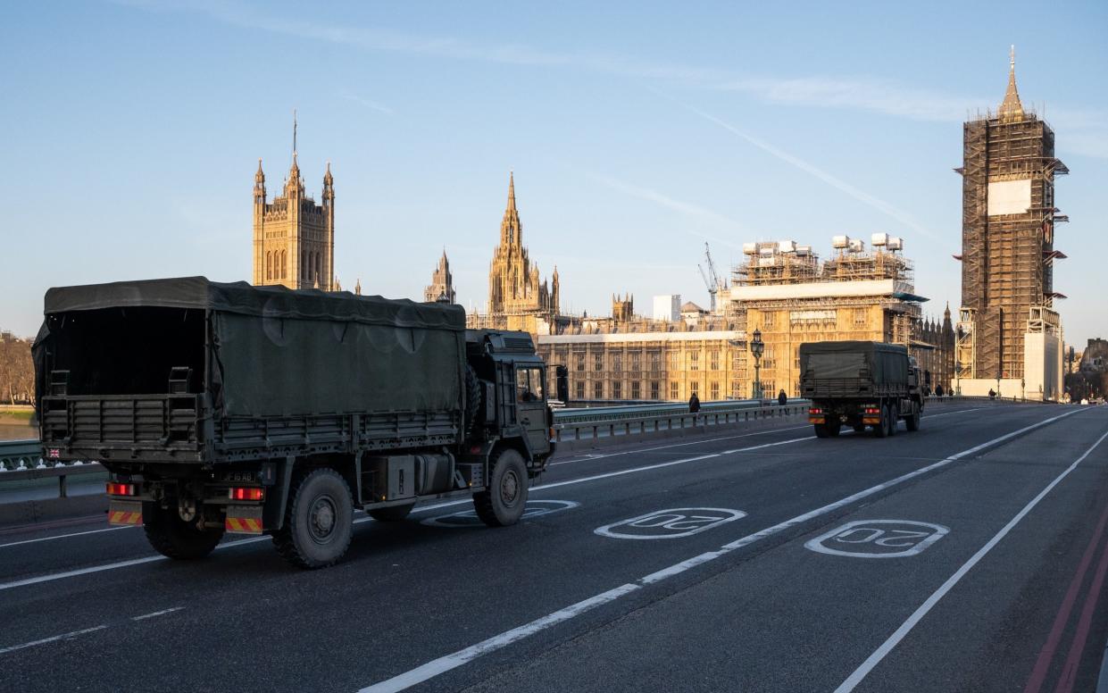 Military vehicles cross Westminster Bridge after members of the 101 Logistic Brigade delivered a consignment of medical masks to St Thomas' hospital  -  /Leon Neal/Getty Images
