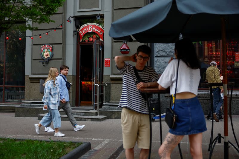 People are seen outside of the Piana Vyshnia (Drunken Cherry) chain's bar in Kyiv