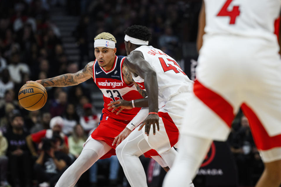 Washington Wizards forward Kyle Kuzma (33) is defended by Toronto Raptors forward Pascal Siakam (43) during first half of an NBA basketball game in Toronto on Monday, Nov. 13, 2023. (Christopher Katsarov/The Canadian Press via AP)