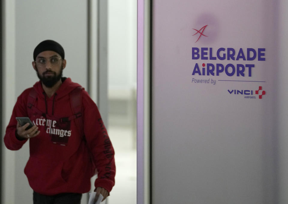 A passenger from a flight from Turkey arrives at Belgrade Nikola Tesla Airport, in Serbia, Tuesday, Oct. 18, 2022. Located at the heart of the so-called Balkan route, Serbia recently has seen a sharp rise in arrivals of migrants passing through the country in search of a better future in the West. (AP Photo/Darko Vojinovic)