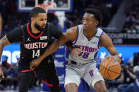 Detroit Pistons guard Saben Lee (38) drives as Houston Rockets guard D.J. Augustin (14) defends during the first half of an NBA basketball game, Saturday, Dec. 18, 2021, in Detroit. (AP Photo/Carlos Osorio)
