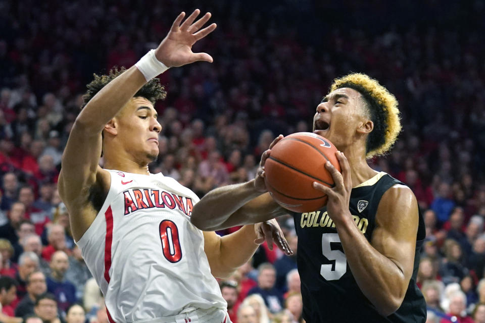 Colorado guard D'Shawn Schwartz (5) drives on Arizona guard Josh Green during the first half of an NCAA college basketball game Saturday, Jan. 18, 2020, in Tucson, Ariz. (AP Photo/Rick Scuteri)