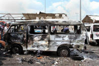 The shell of a burned minibus remains at the site of a suicide bombing in the coastal town of Tartus, Syria, on May 23, 2016. (SANA via AP)