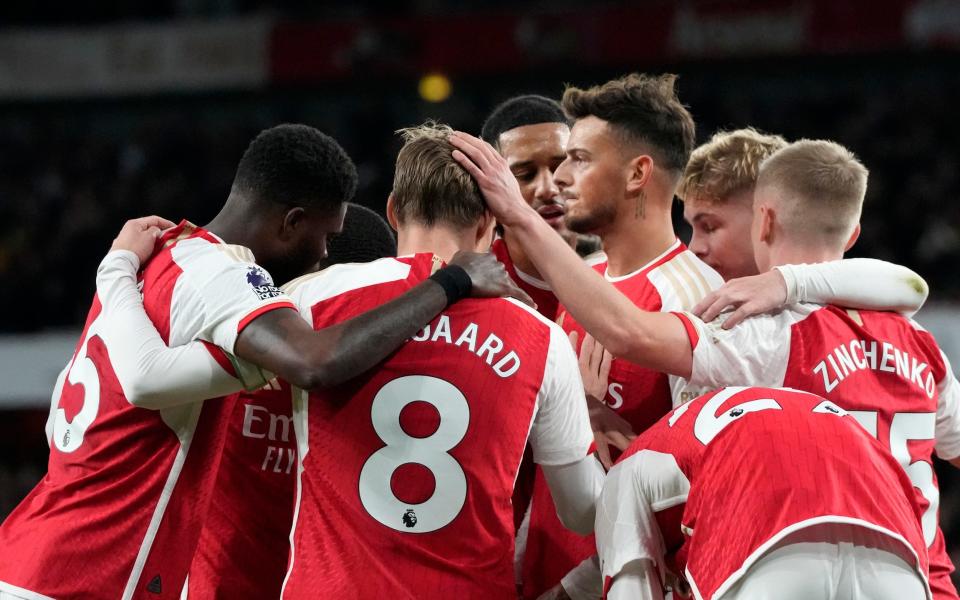 Arsenal players celebrate after Arsenal's Martin Odegaard scored his side's opening goal during the English Premier League soccer match between Arsenal and Luton Town at the Emirates Stadium, London, Wednesday, Apr. 3, 2024.