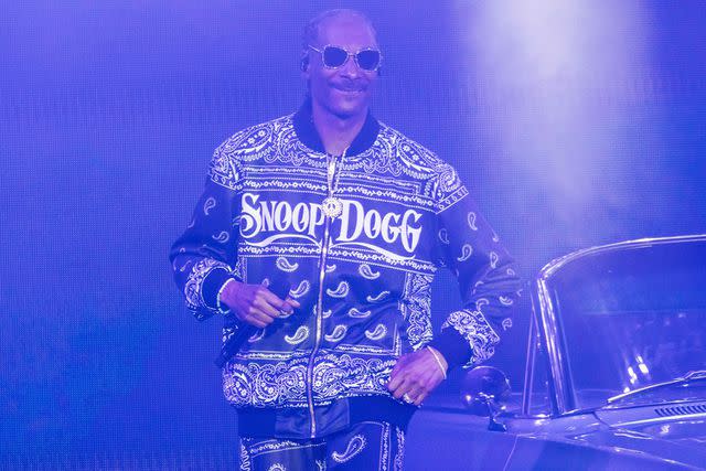 <p>John D Shearer/Shutterstock</p> Snoop Dogg performs in Indiana in July 2023