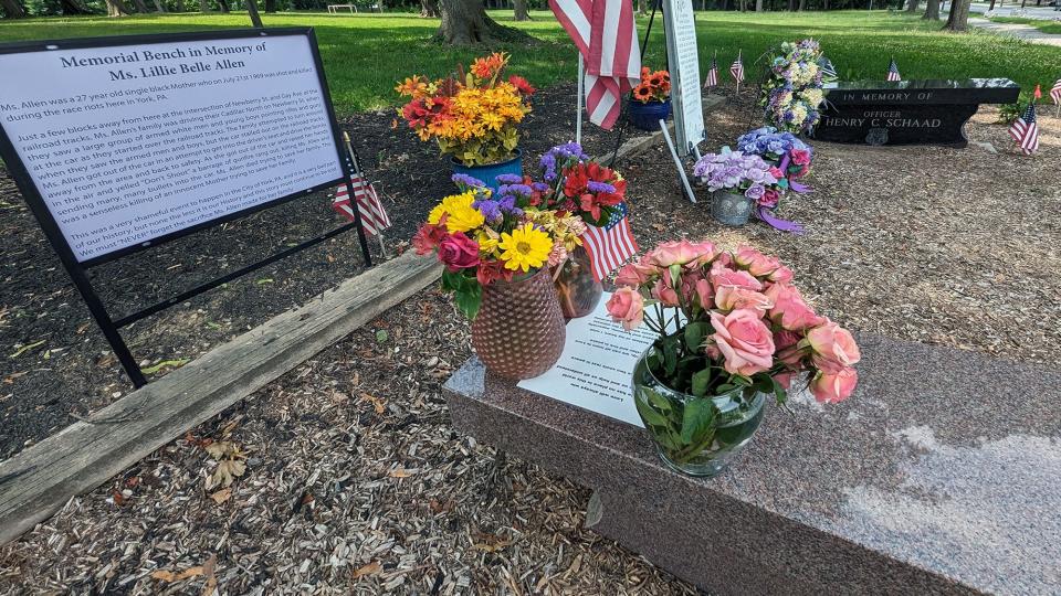The site of the two memorial benches at Farquhar Park on Wednesday, July 12, 2023 for Lillie Belle Allen and Officer Henry C. Schaad that have been kept in fresh flowers for over 1,400 consecutive days.