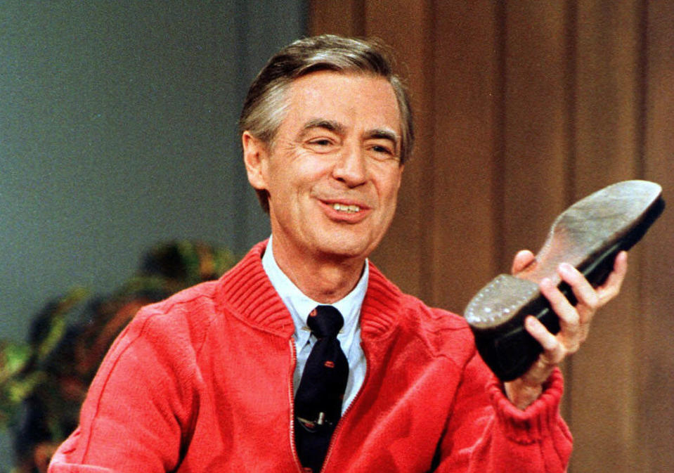 FILE - This June 28, 1989, file photo, shows Fred Rogers as he rehearses the opening of his PBS show "Mister Rogers' Neighborhood" during a taping in Pittsburgh. Rogers' legacy back in the spotlight, PBS wants viewers to remember that public television was the longtime home of “Mister Rogers’ Neighborhood.” PBS stations will air the acclaimed documentary "Won't You Be My Neighbor?" as part of the "Independent Lens" showcase. (AP Photo/Gene J. Puskar, File)