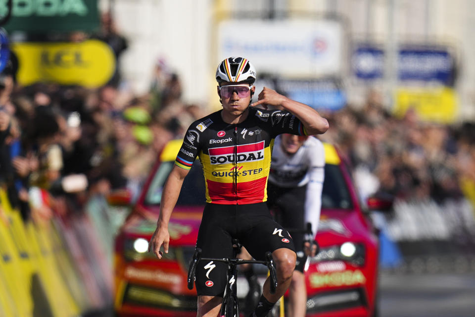 Belgium's Remco Evenepoel celebrates as he crosses the finish line to win the eighth and final stage of the Paris-Nice cycling race in Nice, Sunday, March 10, 2024. (AP Photo/Daniel Cole)