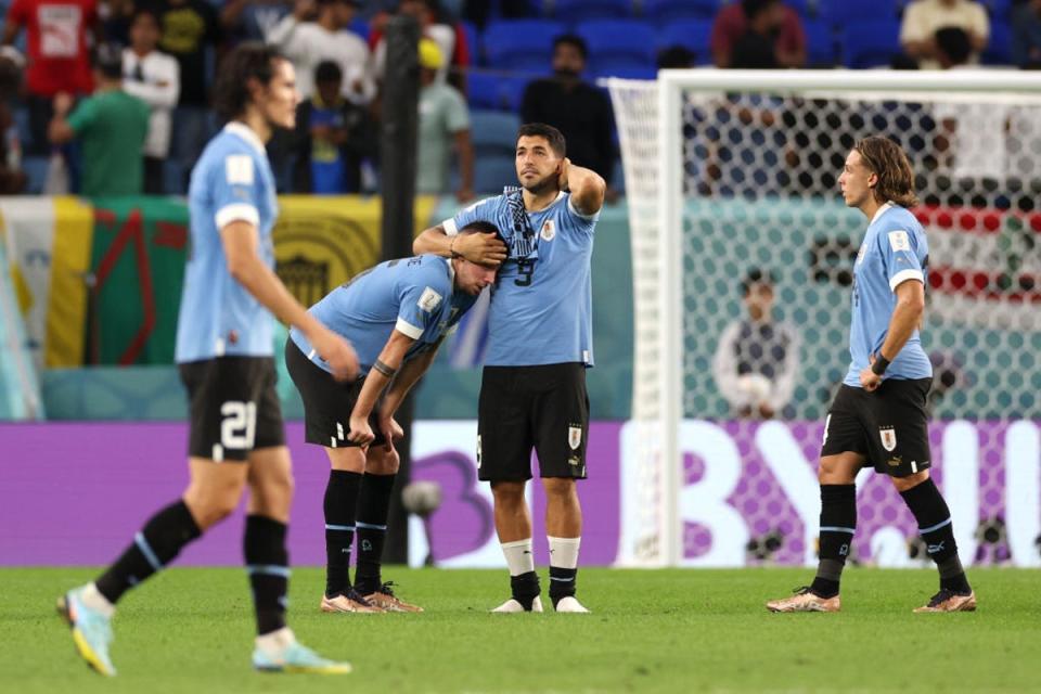 Suarez, centre right, was dejected at the final whistle in what could be his last World Cup game (Getty Images)