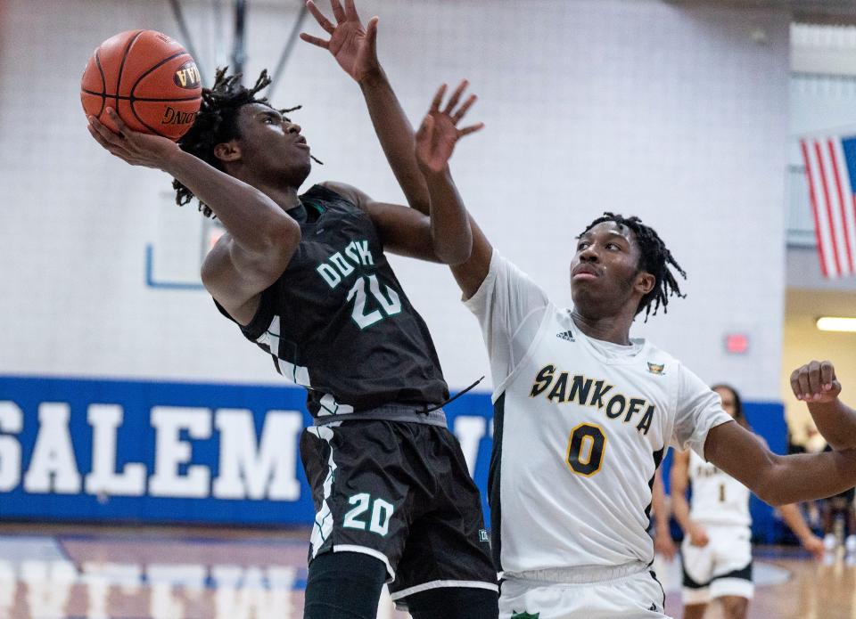 Dock Mennonite's Tony Martin (20) goes for a lay-up against Sankofa Freedom's Nafise Dubose (0) during the PIAA Class 2A boys second-round state playoff basketball game in Bensalem on Wednesday, Mar. 13, 2024.