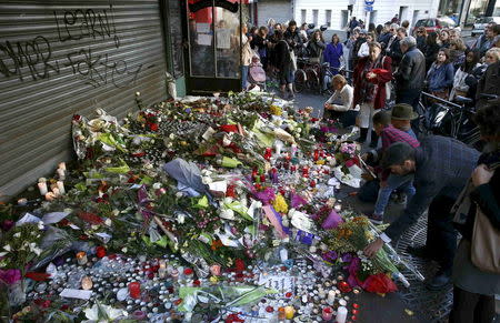 People pay their respect at one of the attack sites in Paris, November 15, 2015. REUTERS/Benoit Tessier
