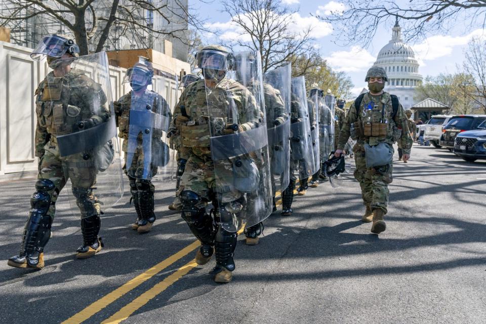 Members of the National Guard leave the Capitol perimeter the they had been guarding.