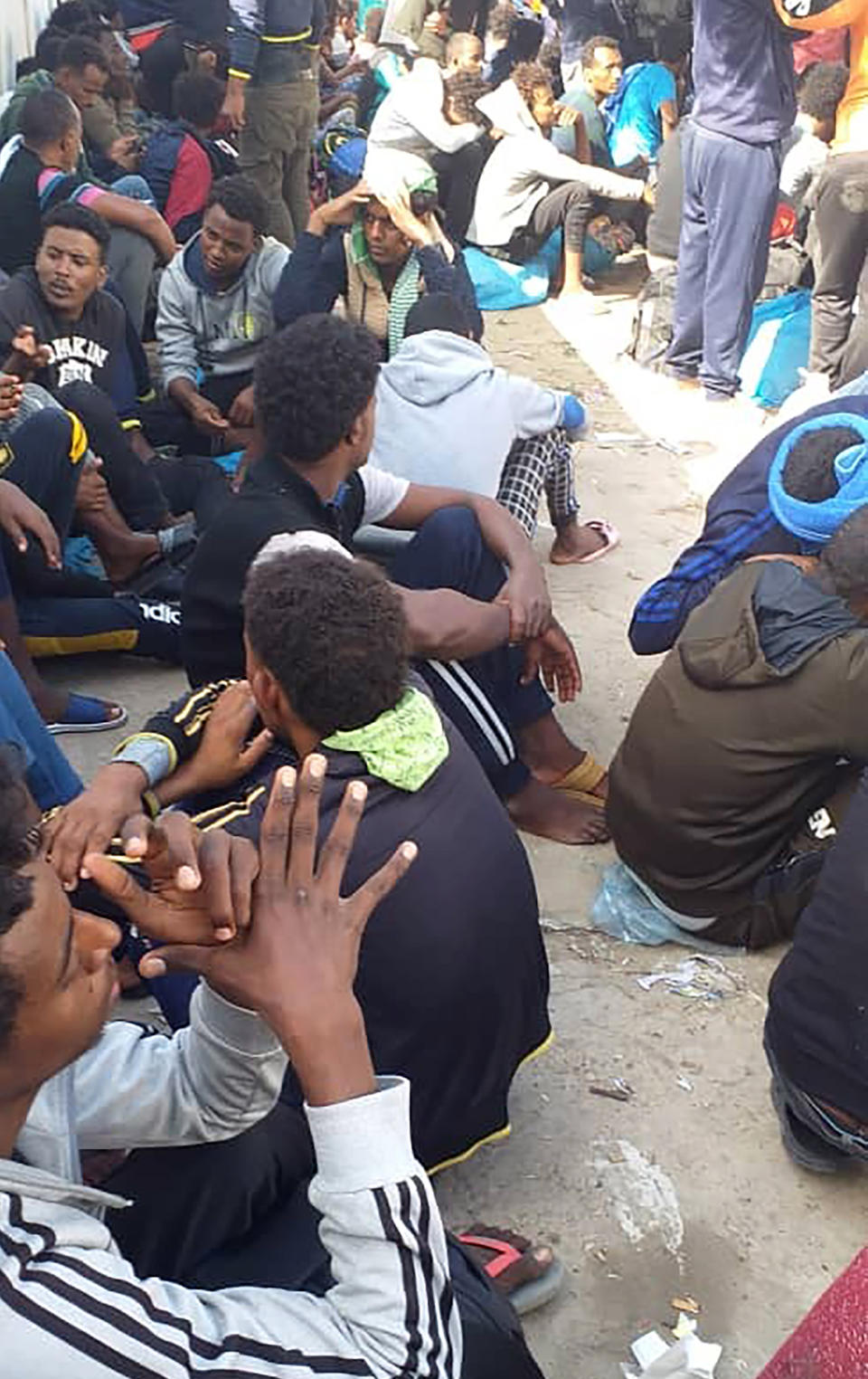 Hundreds of migrants who fled a detention center in coastal Libya crowd around a U.N. facility in Tripoli, Libya, Wednesday, Oct. 30, 2019. Around 450 people left Abu Salim detention center late Tuesday. One of the migrants, as well as activists, say they were forced to beg for money from families to pay police to buy them food. Those who couldn't pay went hungry. (AP Photo)