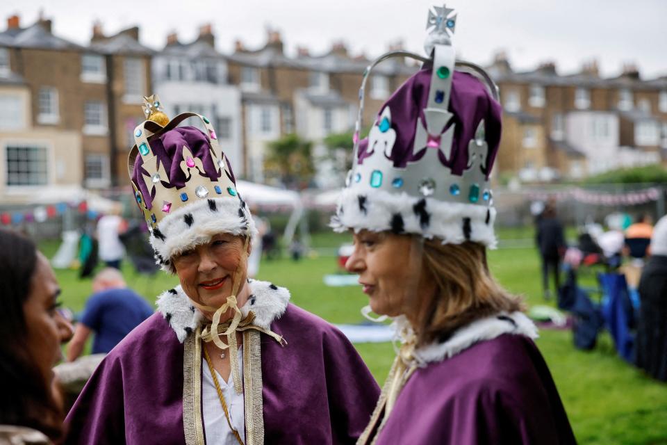 Royal fans dressed in royal-themed costumes attend a picnic while waiting for a coronation concert at Windsor Castle (Reuters)