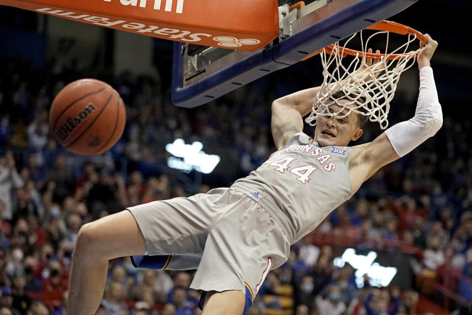 Kansas' Mitch Lightfoot dunks the ball during the first half of an NCAA college basketball game against Nevada Wednesday, Dec. 29, 2021, in Lawrence, Kan. (AP Photo/Charlie Riedel)