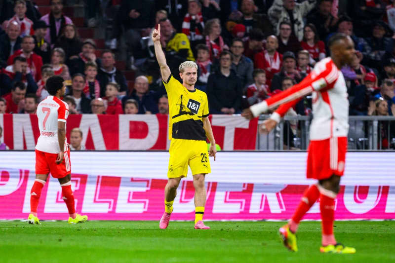 Dortmund's Julian Ryerson celebrates scoring his side's second goal during German Bundesliga soccer match between Bayern Munich and Borussia Dortmund at the Allianz Arena. Tom Weller/dpa