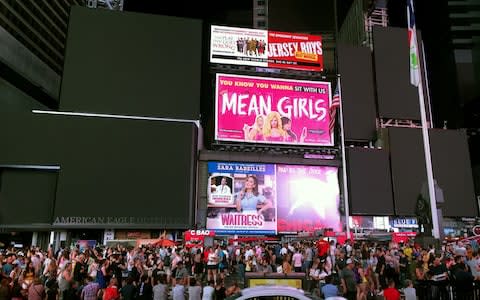 Advertising boards and traffic lights in New York's Times Square went dark - Credit: AFP