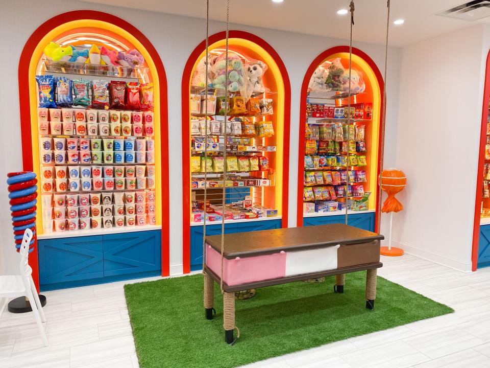 The Ice Cream Sandwich Swing at Sweet Noshings at 541 Perkins Ext. in East Memphis. The seating area includes tables with gumball stands and hot pink "melting" ice cream benches.