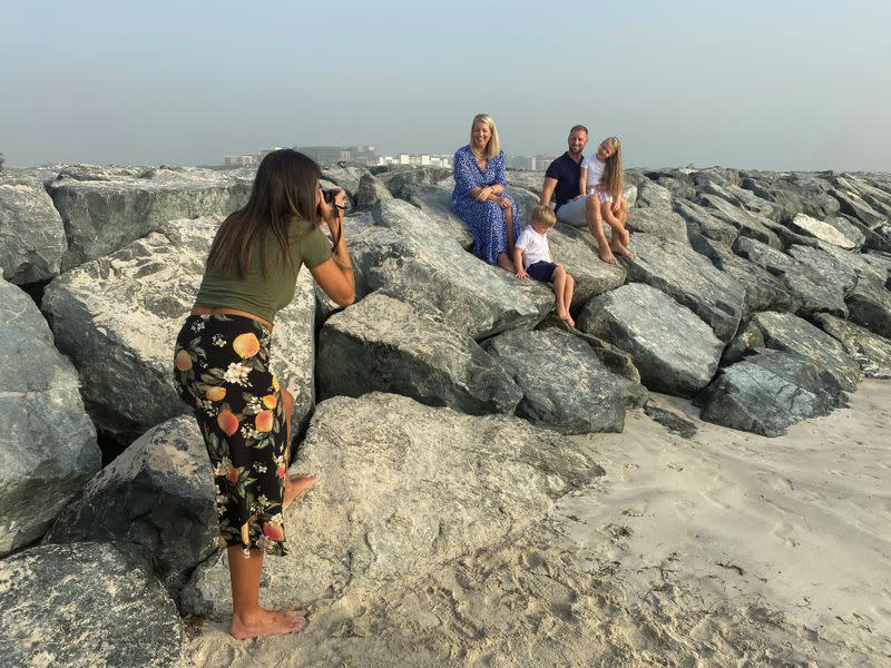 Paula Hainey, a photographer gives a free family photo session at a beach to a family leaving Dubai for the UK, in Dubai