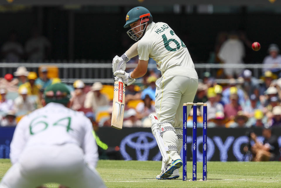 Australia's Travis Head plays and misses at the ball during day two of the first cricket test between South Africa and Australia at the Gabba in Brisbane, Australia, Sunday, Dec.18, 2022. (AP Photo/Tertius Pickard)