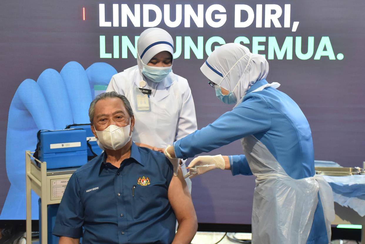 Malaysia's Prime Minister Muhyiddin Yassin receives the first dose of the Pfizer-BioNTech COVID-19 vaccine at a clinic in Putrajaya, Malaysia on Wednesday, Feb. 24, 2021.