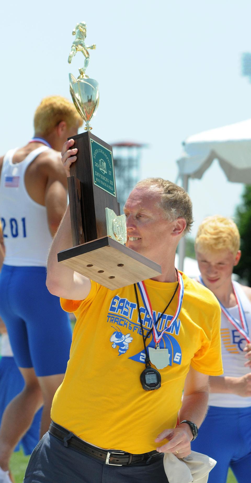 East Canton's Tom Loy, shown here with the Hornets' 2017 Division III state championship trophy, was named the Inter-Valley Conference Boys Track and Field Coach of the Year.