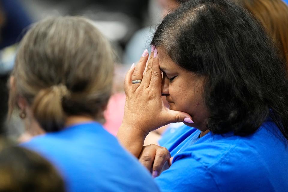 A Cranbrook Elementary supporter waits for the announcement of school closures and consolidations during a meeting of the Columbus City Schools board.