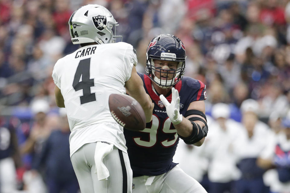 Houston Texans defensive end J.J. Watt (99) blocks a pass by Oakland Raiders quarterback Derek Carr (4) during the first half of an NFL football game Sunday, Oct. 27, 2019, in Houston. (AP Photo/Michael Wyke)