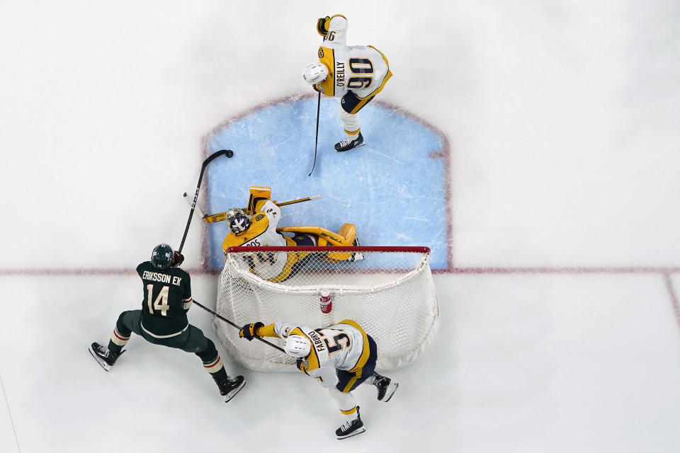 Minnesota Wild center Joel Eriksson Ek (14) attempts to shootas Nashville Predators goaltender Juuse Saros (74) defends during the third period of an NHL hockey game Thursday, Jan. 25, 2024, in St. Paul, Minn. (AP Photo/Abbie Parr)