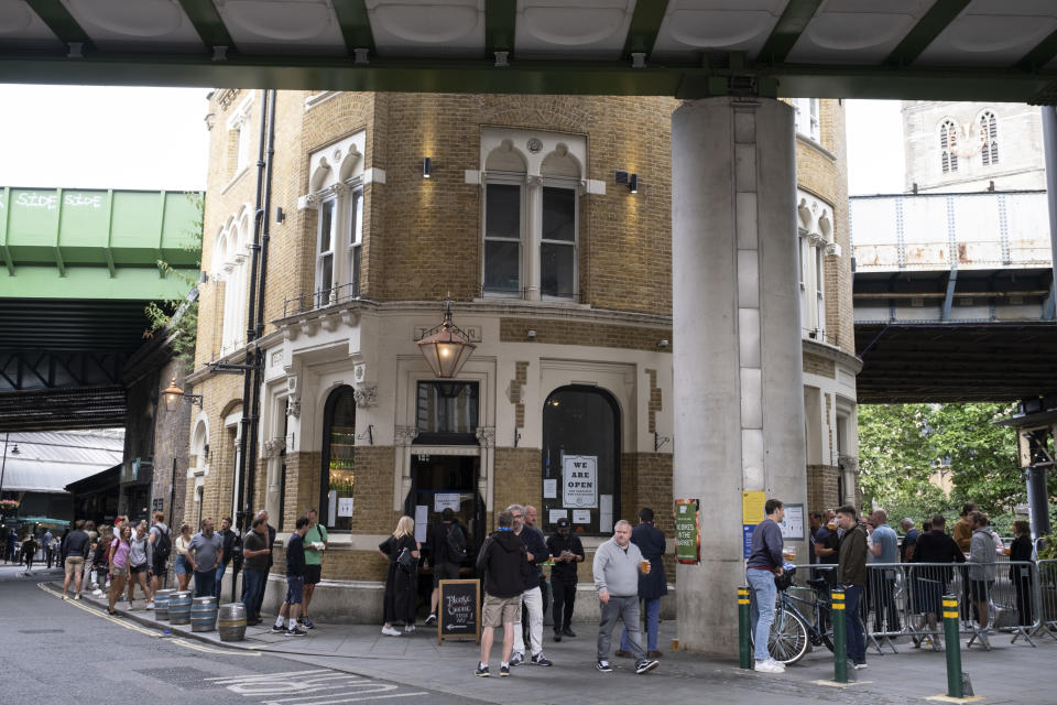 The Globe pub in Borough Market selling takeaway drinks to a queue of people who congregate outside under coronavirus lockdown on 1st July 2020 in London, England, United Kingdom. Pubs have used this technique to remain in business to a degree while they are not allowed to open. As the July deadline approaces and government will relax it's lockdown rules further, the central London remains very quiet, while some non-essential shops are allowed to open with individual shops setting up 'social distancing' systems. (photo by Mike Kemp/In PIctures via Getty Images)