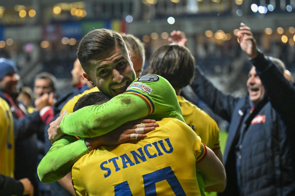 Romania's players celebrate at the end of the Euro 2024 group I qualifying soccer match between Israel and Romania at the Pancho Arena in Felcsut, Hungary, Saturday, Nov. 18, 2023. (AP Photo/Denes Erdos)