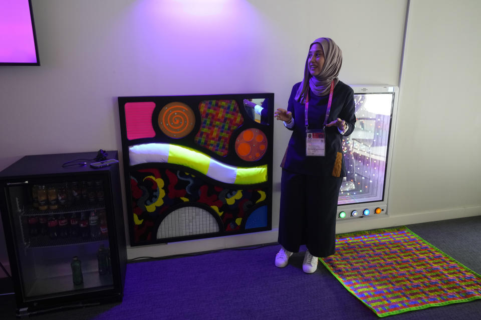 Raana Smith, co-founder of Sensory Souk, speaks during a demonstration of a sensory room at the Lusail Stadium in Lusail, Qatar, Saturday, Dec. 10, 2022. The "sensory rooms," set up for the first time in the World Cup at three stadiums in Qatar, provide a calm refuge for children and young adults with autism, learning difficulties or other sensory access requirements. (AP Photo/Andre Penner)