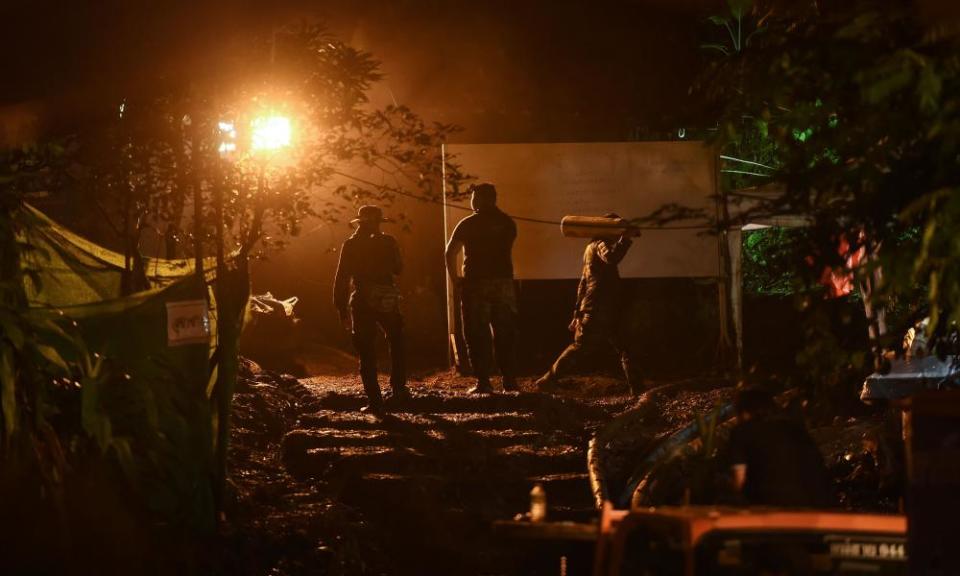 Rescue workers carry oxygen tanks to Tham Luang cave in 2018 during the rescue mission to save the trapped football team.