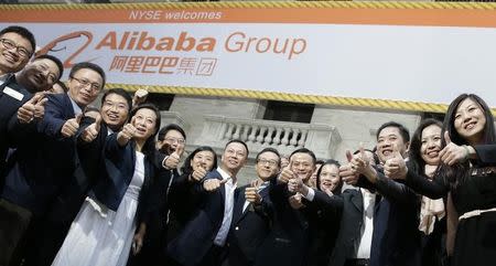 Alibaba Group Holding Ltd founder Jack Ma (2nd L) poses as he arrives at the New York Stock Exchange for his company's initial public offering (IPO) under the ticker "BABA" in New York September 19, 2014. REUTERS/Brendan McDermid