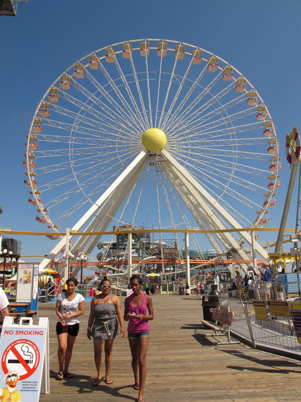 In this July 2, 2012 photo visitors walk on the Wildwood, N.J., boardwalk. A measure being pushed by some New Jersey lawmakers would allow boardwalks to use money reserved for road repairs. It was inspired by the poor condition of the Wildwood boardwalk's support structure, which is badly in need of repairs. (AP Photo/Wayne Parry)