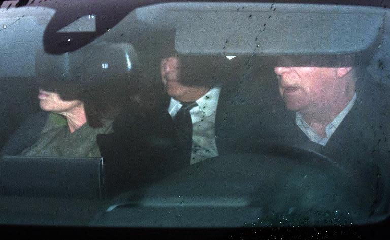 Former IMF chief Dominique Strauss-Kahn (C) arrives to attend his trial in Lille