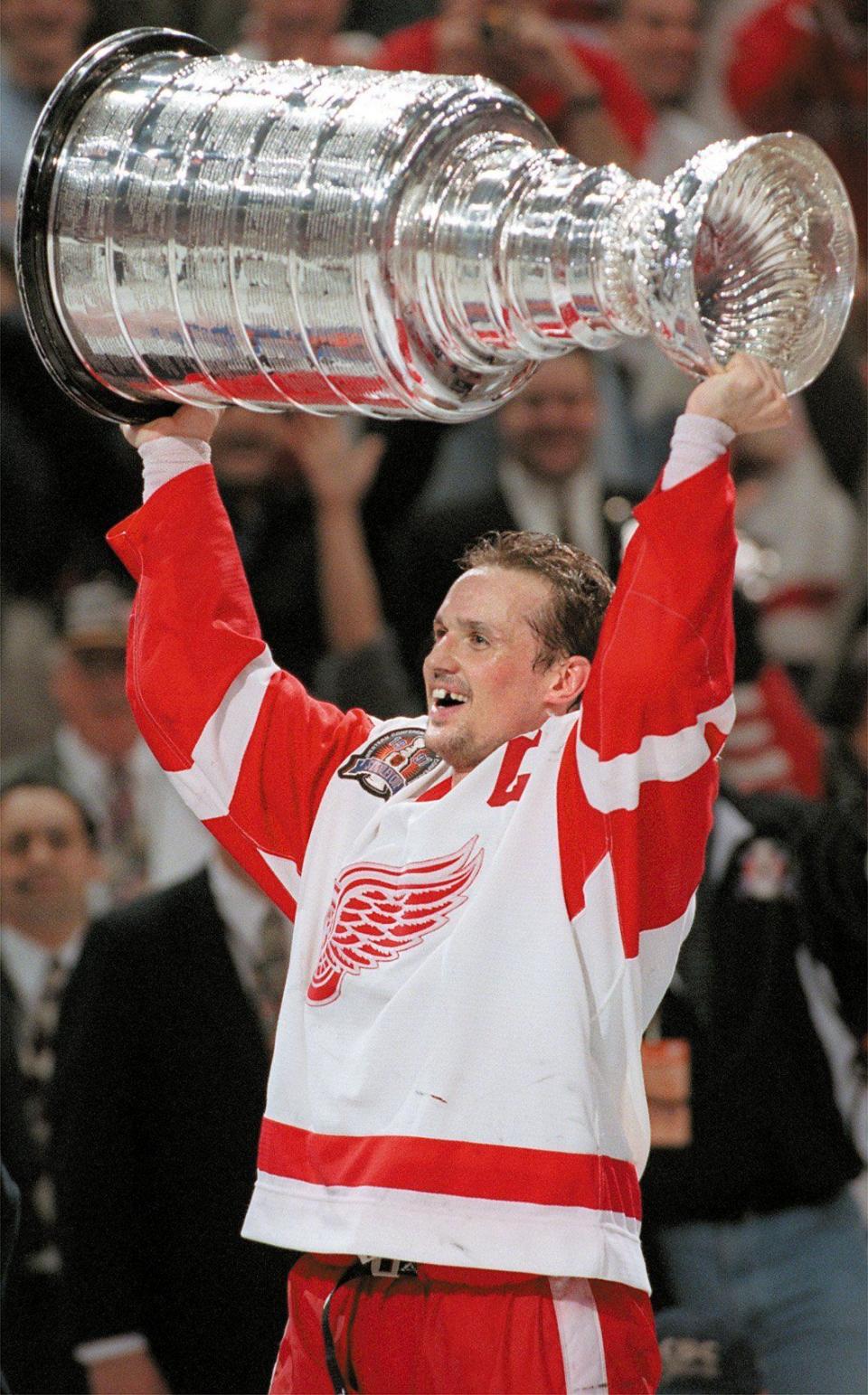 Red Wings captain Steve Yzerman holds the Stanley Cup in celebration of the Wings' four-game sweep over the Flyers at Joe Louis Arena on June 7, 1997.