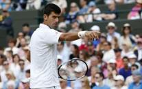 Novak Djokovic of Serbia requests his towel from a ball girl during his match against Kevin Anderson of South Africa at the Wimbledon Tennis Championships in London, July 7, 2015. REUTERS/Suzanne Plunkett