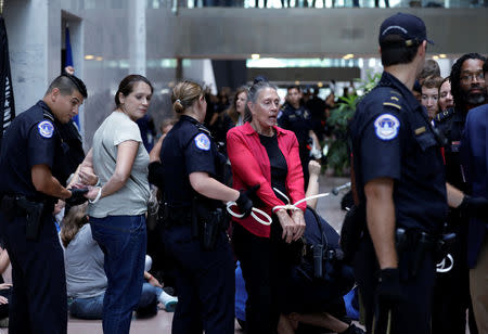 Protesters are arrested during a demonstration in opposition to U.S. President Donald Trump's Supreme Court nominee Brett Kavanaugh on Capitol Hill in Washington, U.S., September 20, 2018. REUTERS/Yuri Gripas