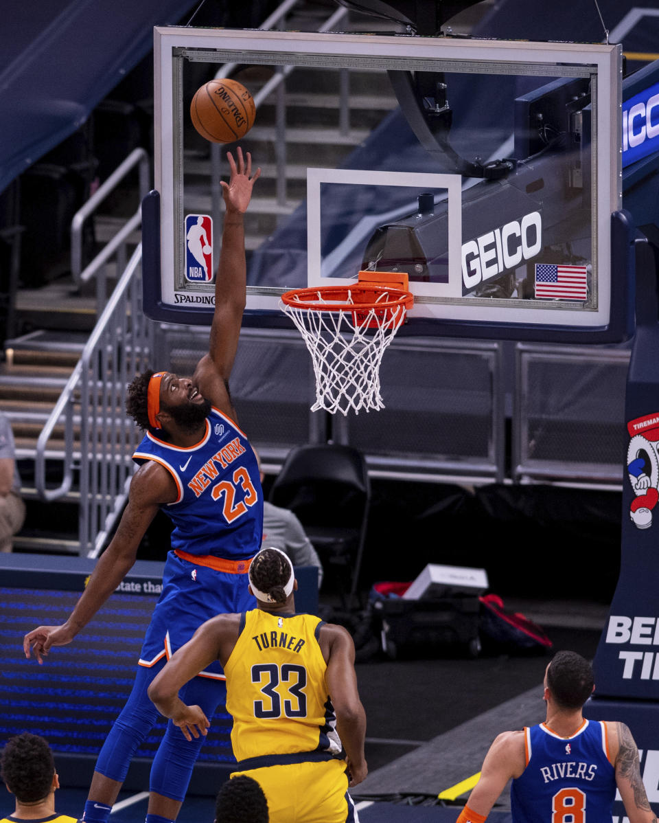 New York Knicks center Mitchell Robinson (23) tries to reach a pass from a teammate during the first half of an NBA basketball game against the Indiana Pacers in Indianapolis, Saturday, Jan. 2, 2021. (AP Photo/Doug McSchooler)